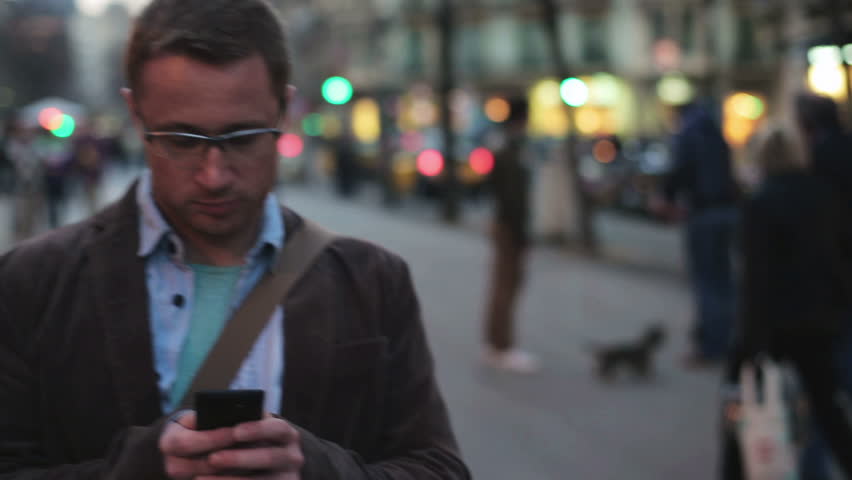 man walking along the street and texting on his cellphone
 Royalty-Free Stock Footage #6080984