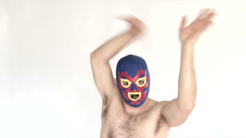 Model released man in studio wearing blue lucha libre mask showing off ridiculous skills.