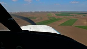 Airplane landing ; Landing of a small sports plane on a grass runway.view from the cockpit,video clip