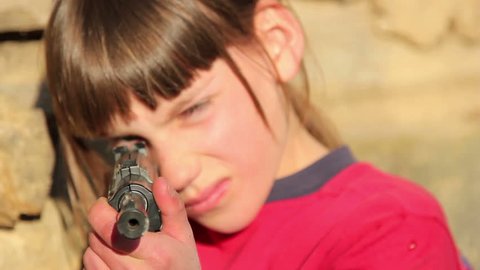 Boy with gun.Boy playing weapon.Little warrior.Teenager a gun aiming.Close up -footage 1920x1080p. 