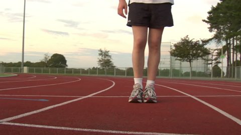 A runners feet from a unique vantage point on a running track.