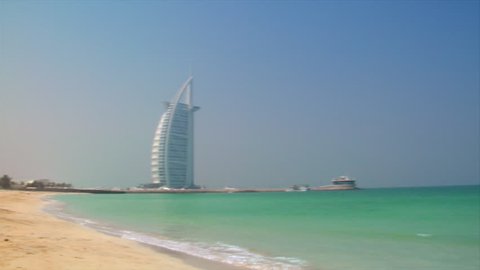 DUBAI - SEPTEMBER 9: A pan shot shows Jumeirah Beach with the famous Burj al Arab Hotel, the Jumeirah Beach  on September 9.2009, Dubai, UAE. 