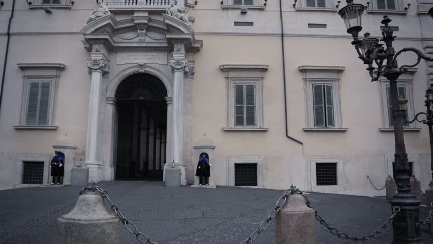 Front facade of an european parliament  and police officers guarding each side of the door