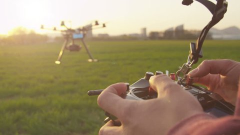 SLOW MOTION: Drone operator flying multicopter outdoors