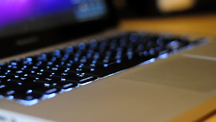 Typing on a laptop.  Shallow depth of field.