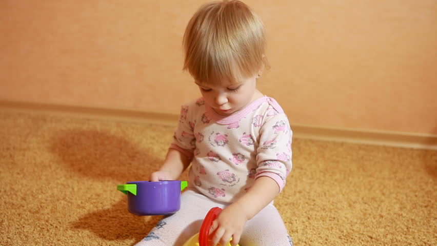 Child playing with a plastic utensils