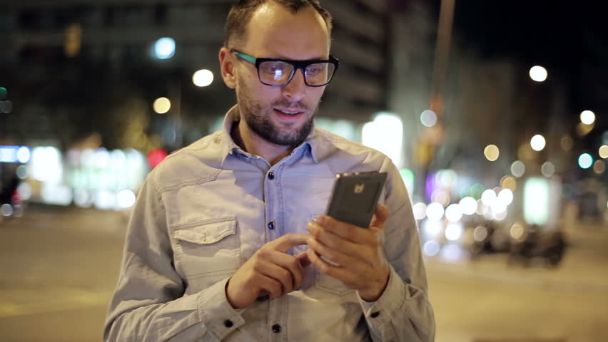 Young man with smartphone in night city, steadicam shot
 Royalty-Free Stock Footage #6101978