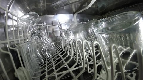 Dishwasher washes dishes glasses utensils clean and bright - an inside look.