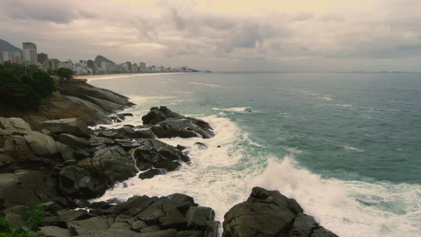 Slow motion shot of rocks and waves along the coastline of Rio de Janeiro,
