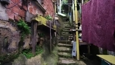 Tracking shot of crowded shanties along the stairs in a favela in Rio de Janeiro, Brazil