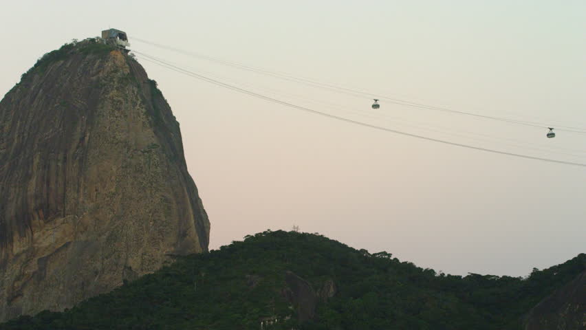 Static shot of a cable cars ascending and descending from Sugarloaf Mountain in