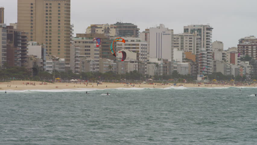 group of about five parasailing surfers in Copacabana beach.