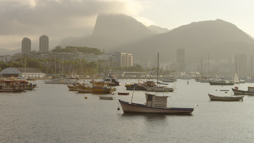 Pan of anchored boats in a hazy Rio marina.