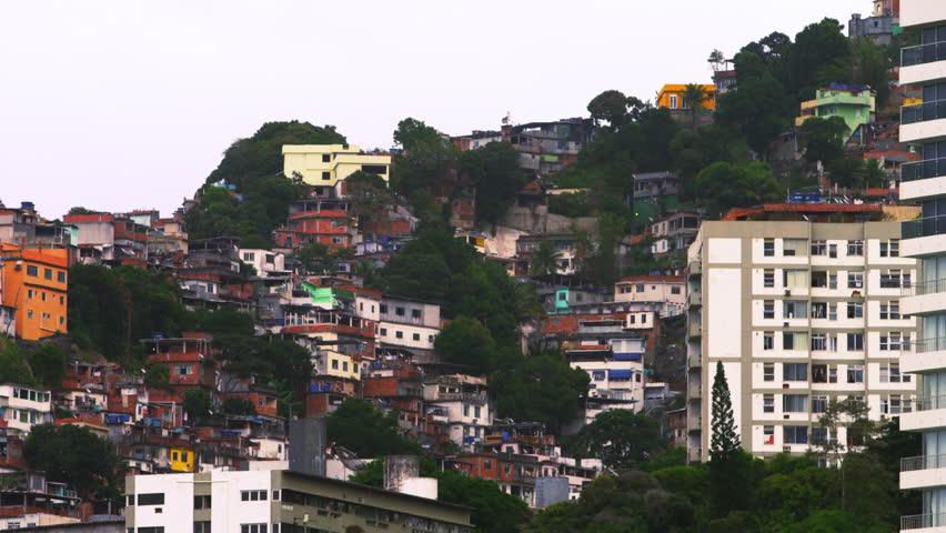 Panning shot of houses at a favela along the mountainside in Rio de Janeiro,