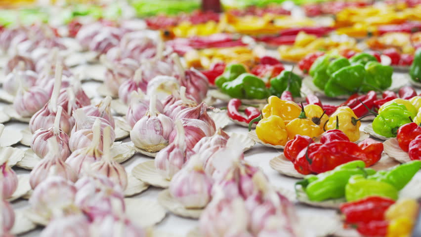 Static shot of garlic and different varieties of pepper in a market in Rio de