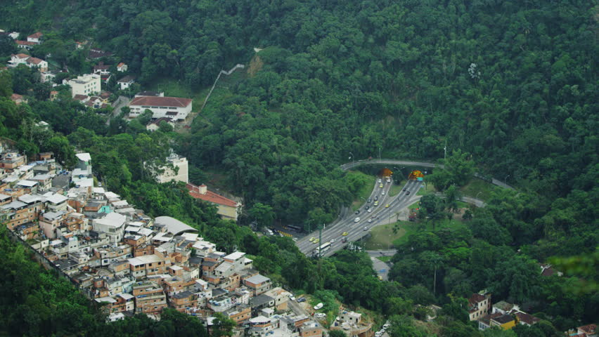 Eagles fly over a city bluff overlooking a tunneled intersection in Rio de