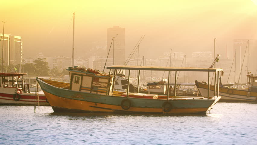 Static shot of a lone boat floating in Guanabara Bay.