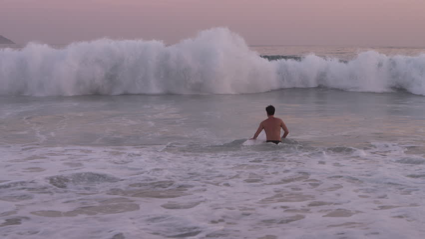 Male surfer trying to catch a wave
