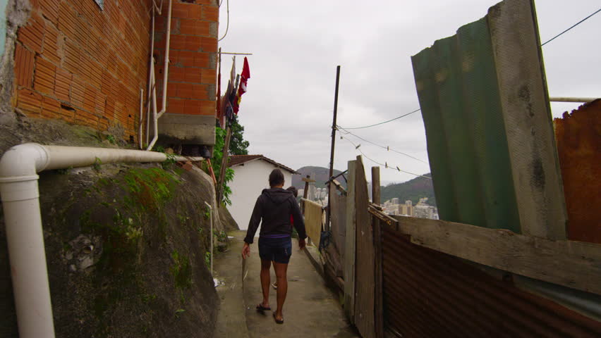 Slow dolly shot of walking kids in a favela on June 23, 2013 in Rio de Janeiro,