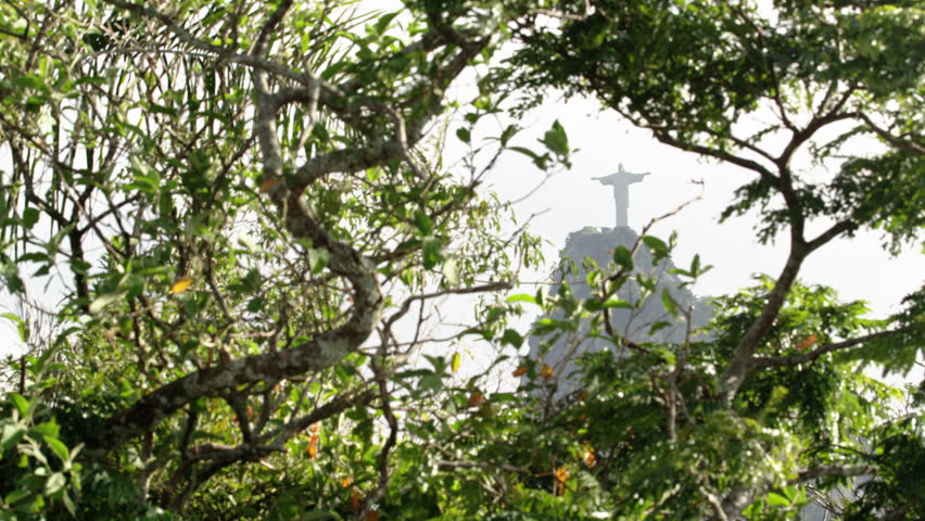 Christ statue visible through tree branches