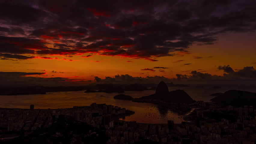Sunrise time-lapse of Sugar Loaf mountain from behind Rio.