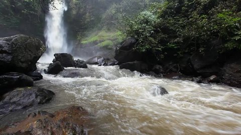 River and waterfall with brown water color in Curug Panganten Indonesia 