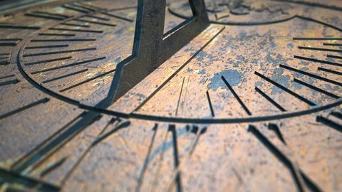 A macro closeup time-lapse of a camera panning across a metal sundial with time passing over a day