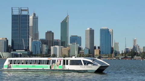 PERTH, WA/AUSTRALIA - FEBRUARY 19, 2014: Phillip Pendal ferry arrives at Mends Street jetty with skyline in background. Transperth ferry service runs from Barrack to Mends Street, South Perth
