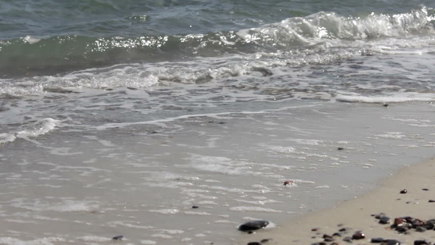 Wave Foam on a Sandy Beach Foamy waves roll over the sandy texture of the beach. | Shutterstock HD Video #6112238