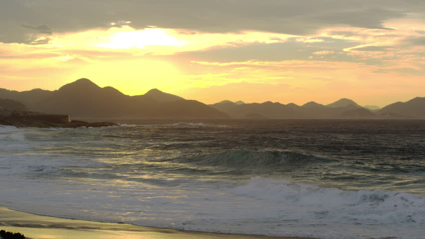 Waves breaking on Ipanema beach at sunset