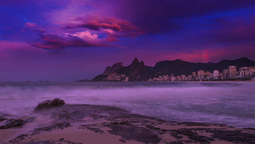 Sliding time-lapse of the beach, and Rio de Janeiro with a rainbow.