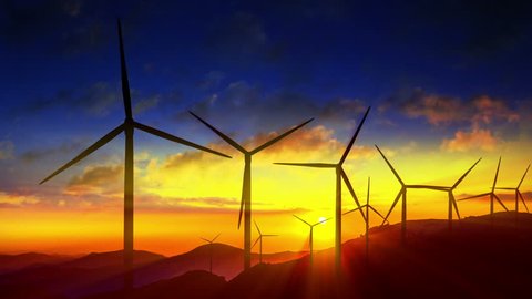 4K Beautiful windmill turbines harnessing clean, green, wind energy silhouetted in the sunrise/sunset sky with sun rays. Green energy. HD Version