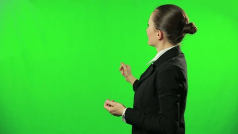 Female weathercaster giving weather report against a green screen