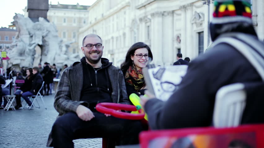 Painter sketch portrait of two lovers, piazza Navona, Rome, Italy