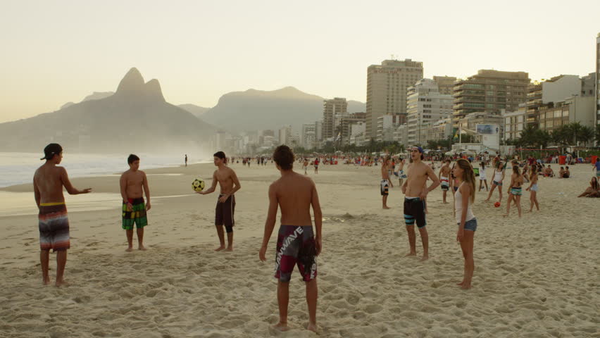 RIO DE JANEIRO, BRAZIL - JUNE 16: Teen bicycle-kicks a football at beach on June