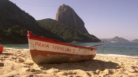 RIO DE JANEIRO, BRAZIL - JUNE: Slow motion pan of a fishing skiff on Red Beach in Rio. Redaktionel stock-video