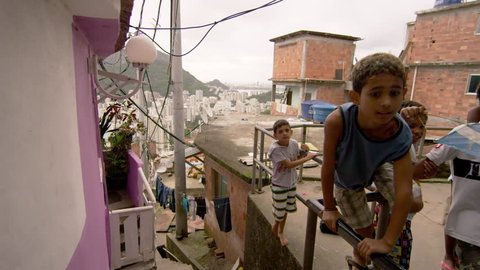 RIO DE JANEIRO, BRAZIL - JUNE 23: Slow dolly shot, favela occupants on Jun 23, 2013 in Rio, Brazil