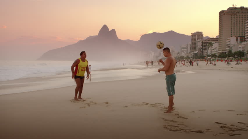 RIO DE JANEIRO, BRAZIL - JUNE: Two men playing football on Ipanema beach