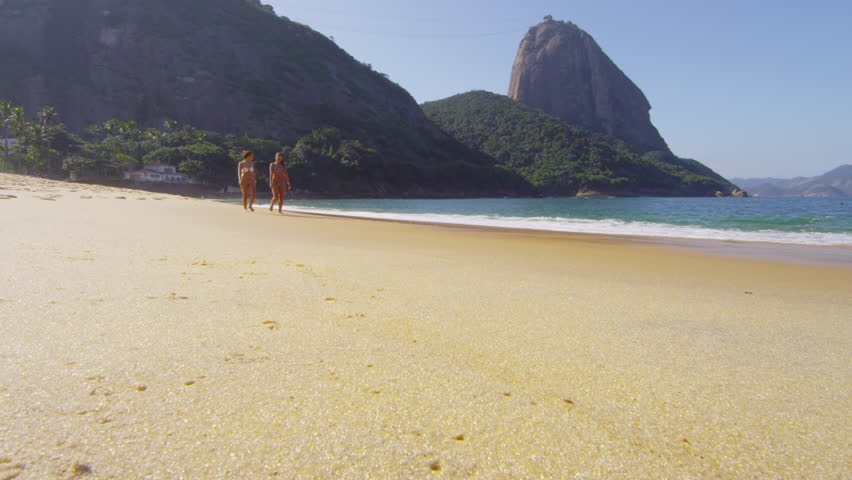 RIO DE JANEIRO, BRAZIL - JUNE: Slow motion of women walking on a Rio beach.