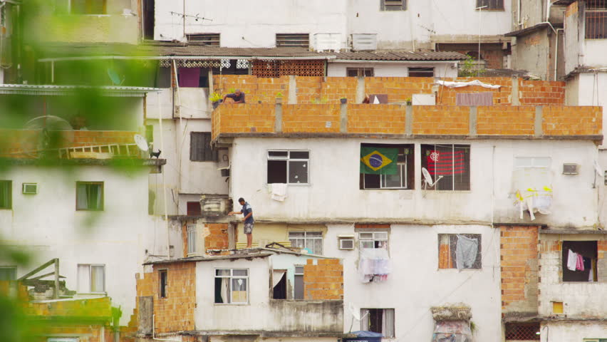RIO DE JANEIRO, BRAZIL - JUNE 23: Static shot of people on rooftops in favela