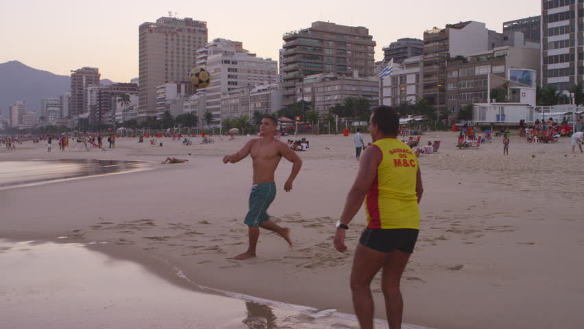 RIO DE JANEIRO, BRAZIL - JUNE: Two men on Ipanema beach playing soccer