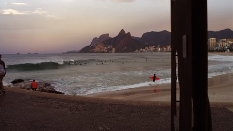 RIO DE JANEIRO, BRAZIL - JUNE: Camera pans to a rainbow in the distance at Ipanema Beach in Rio de Janeiro Redaktionel stock-video