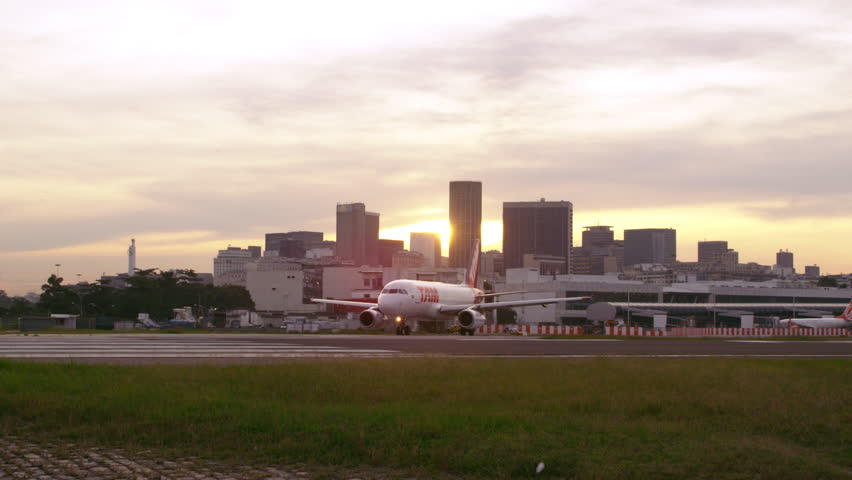 RIO DE JANEIRO, BRAZIL - JUNE 21: Lens flare shot of plane taxiing on runway on