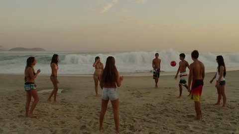 RIO DE JANEIRO, BRAZIL - JUNE: A group of teens playing soccer (football) on Ipanema beach Adlı Haber Amaçlı Stok Video