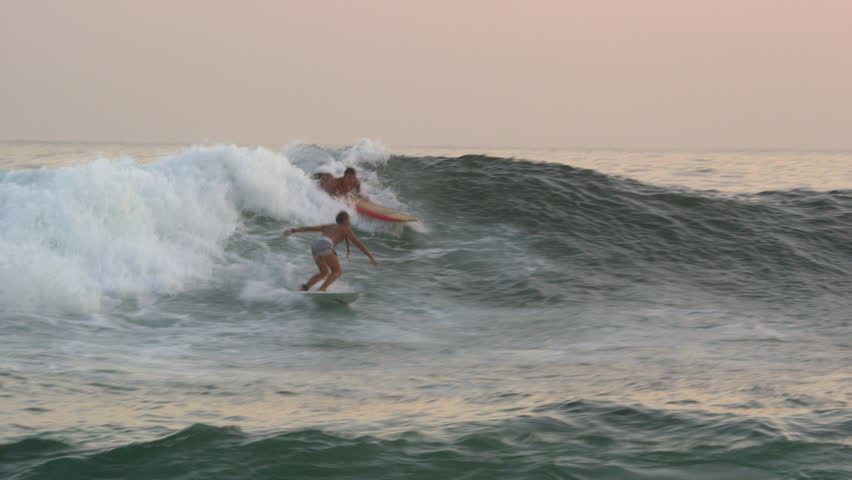 RIO DE JANEIRO, BRAZIL - JUNE: Slow motion, pan shot of surfer riding wave
