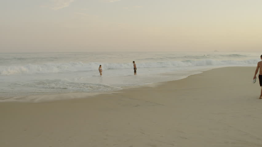 RIO DE JANEIRO, BRAZIL - JUNE 16: Couples enjoy dusk at Ipanema beach on June
