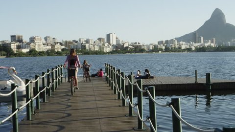 RIO DE JANEIRO, BRAZIL - JUNE: Women biking off small lake pier