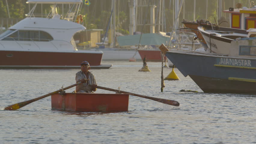 RIO DE JANEIRO, BRAZIL - JUNE: Slow motion of a man rowing a boat amidst a