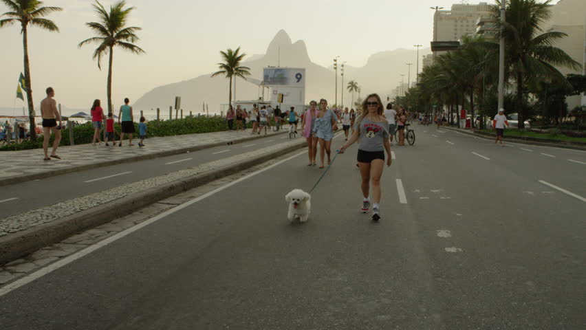 RIO DE JANEIRO, BRAZIL - JUNE: Slow motion tracking shot of a blond girl walking