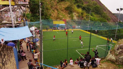 RIO DE JANEIRO, BRAZIL - JUNE 23: Slow tracking shot down stairs of a community soccer game Adlı Haber Amaçlı Stok Video